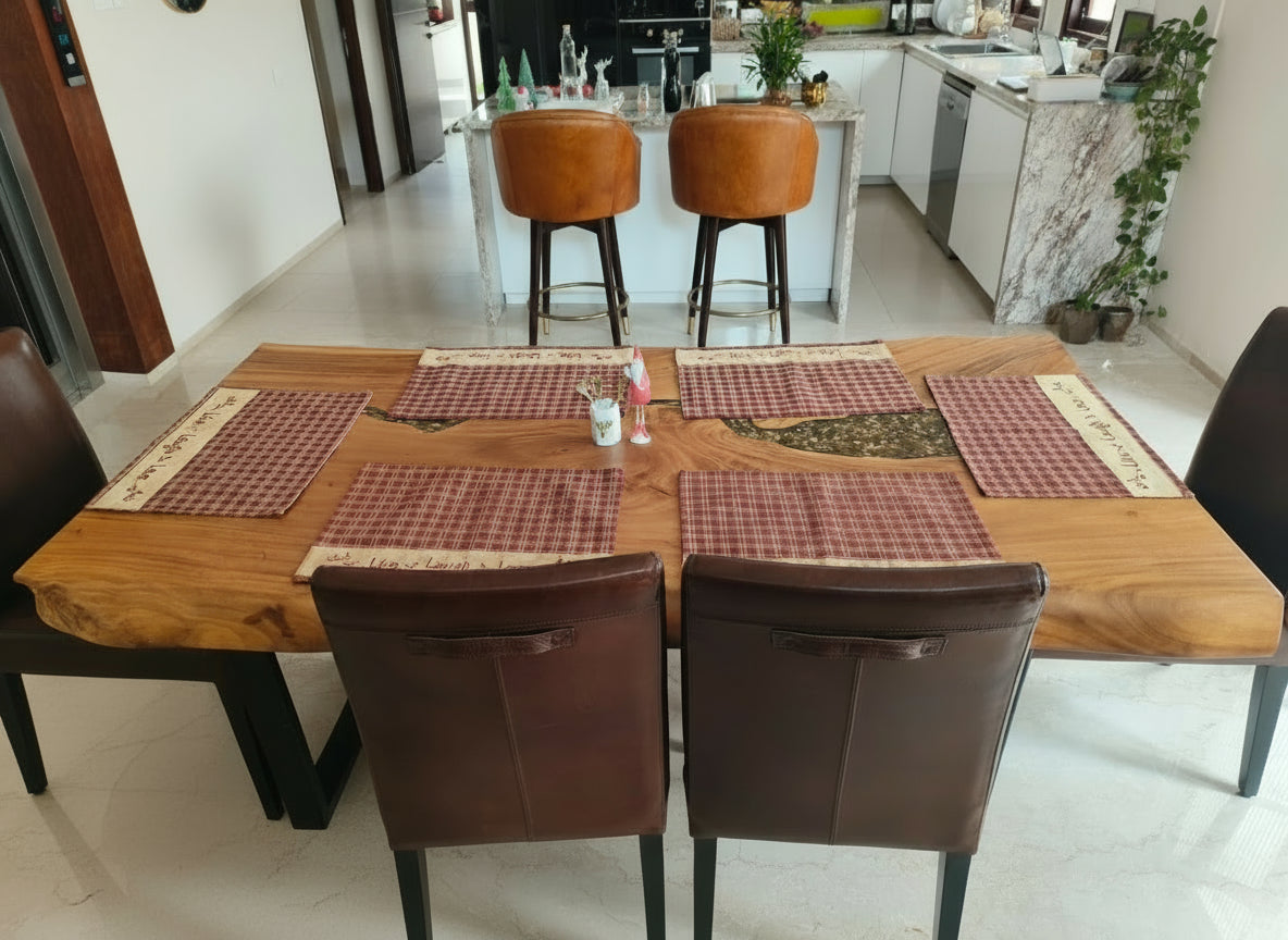 Dining table with placemats and chairs in a kitchen setting