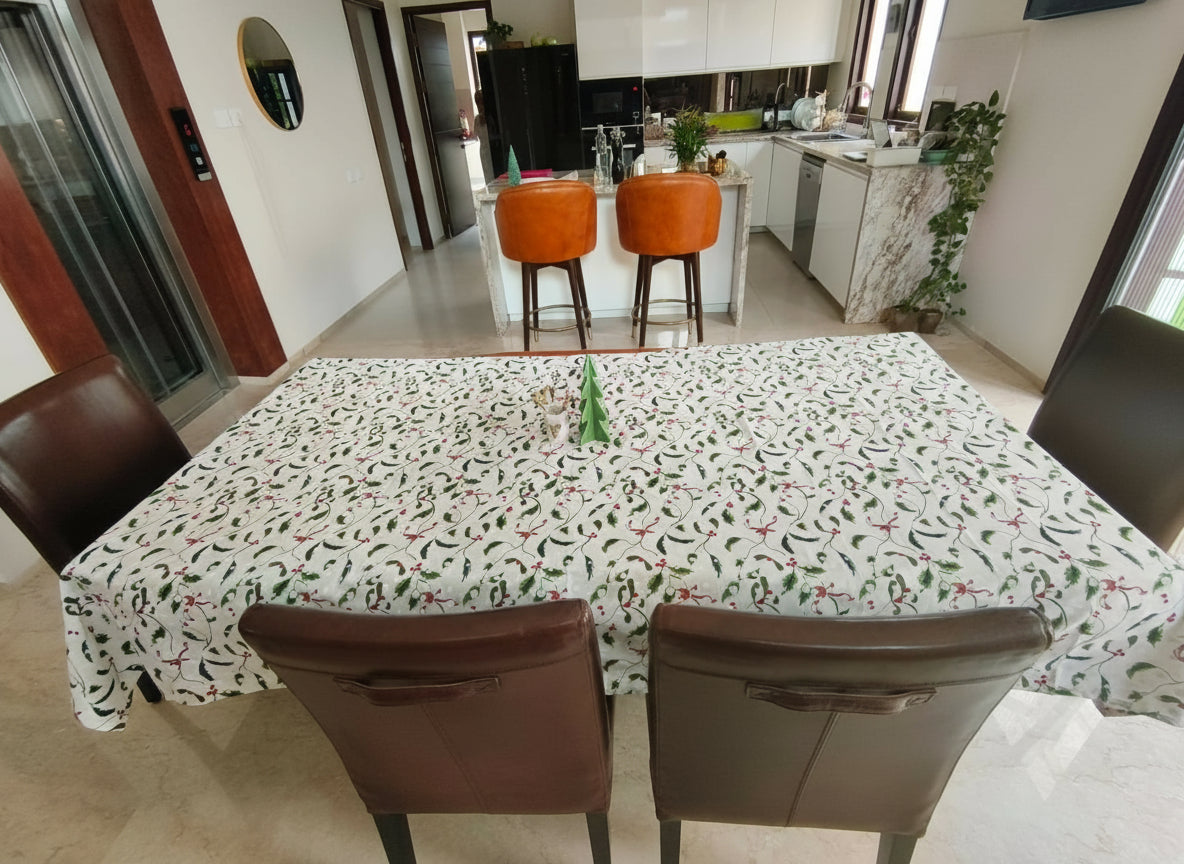 Dining table with a patterned tablecloth in a kitchen setting