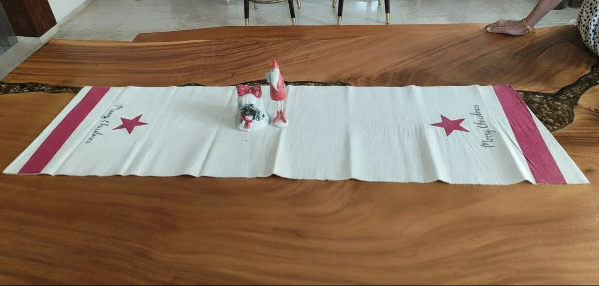 Long wooden object on a table with a kitchen in the background