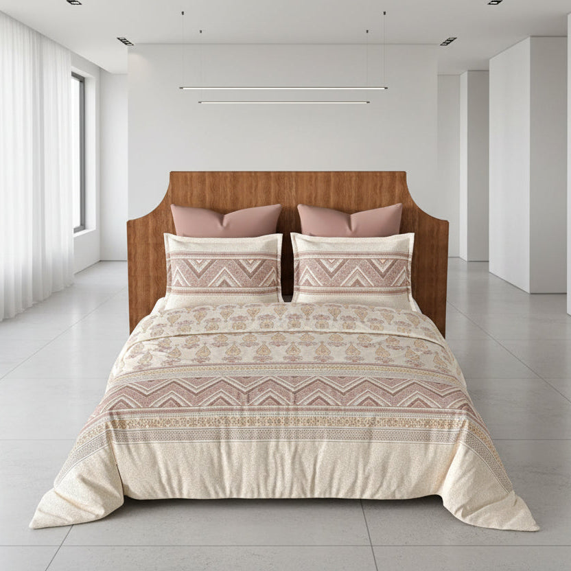 Bed with patterned bedding and pink pillows in a bedroom setting.